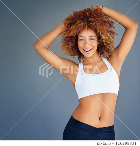 Happy, fitness and portrait of confident woman in studio for exercise, training and workout on blue background. Sports, personal trainer and person with pride smile for wellness, healthy body and gym 116298731