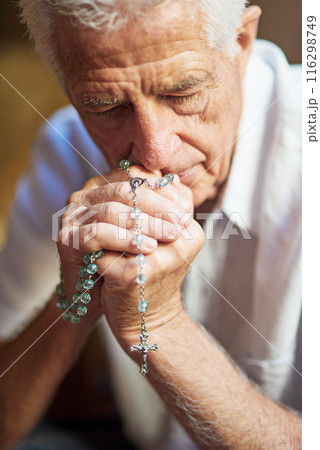 Senior man, catholic and praying in home with rosary or hail mary for God, Jesus and heaven. Elderly person, praise and worship with crucifix for faith, religion and as Christian by apostles creed 116298749