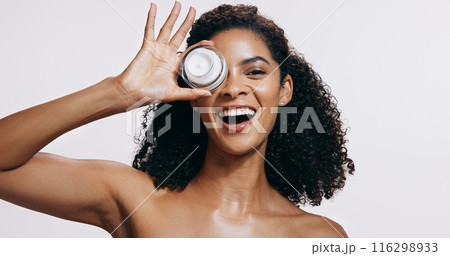 Black woman, skincare and portrait with cream, cosmetics and sunscreen product with smile from beauty. White background, facial and skin glow with eco friendly and anti aging face lotion in studio 116298933