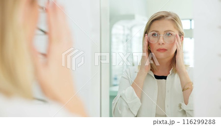 Woman, glasses and mirror at store for vision, eye care and wellness for eyesight, frame and choice. Person, customer and check reflection with decision for optometry, health and style at retail shop 116299288
