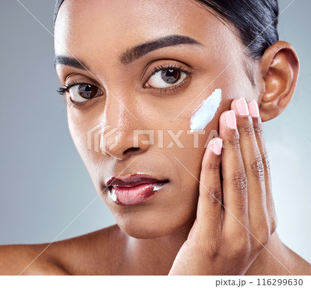 Beauty, skincare and Indian woman with hand and cream, close up and studio on gray background. Collagen, dermatology and thinking female person for selfcare, hydration and hyaluronic acid or retinol 116299630
