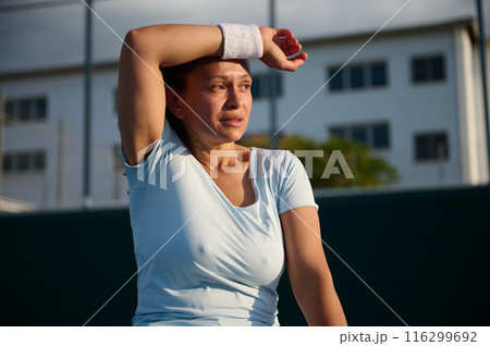 Woman resting after outdoor workout on a sunny day Woman resting after outdoor workout on a sunny day 116299692