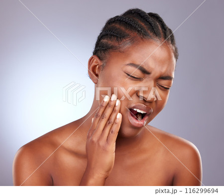 Toothache, black woman and dental pain in studio with cavity, gum disease and bacteria from gingivitis infection. Healthcare, medical and mouth injury, accident and teeth problem on purple background Toothache, black woman and dental pain in studio with cavity, gum disease and bacteria from gingivitis infection. Healthcare, medical and mouth injury, accident and teeth problem on purple background 116299694