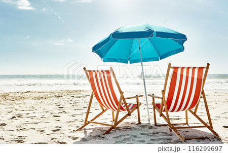 Rest, relax and beach chairs with umbrella on sand for vacation, holiday or weekend break. Summer, blue sky and seats in nature with ocean water for peace, travel or tourism in bali getaway Rest, relax and beach chairs with umbrella on sand for vacation, holiday or weekend break. Summer, blue sky and seats in nature with ocean water for peace, travel or tourism in bali getaway 116299697