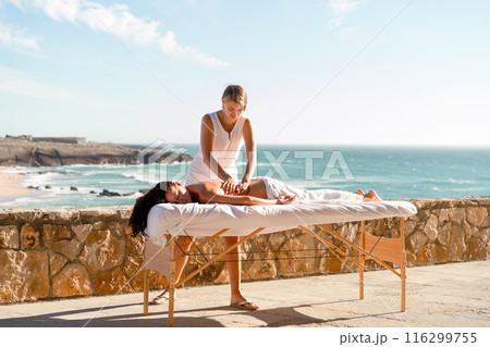 Masseur massaging female outdoor full length 116299755
