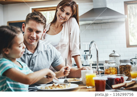 Love, breakfast pancakes and hungry family with children, mother and father, bonding and prepare ingredients. Morning food, cooking and happy woman, man and daughter in home kitchen eating meal 116299756