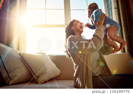 Mother, infant and embrace on sofa in living room with love for relationship with new born, care and playing. Light, smile and relax with baby or child, happiness and wellness on couch in house. Mother, infant and embrace on sofa in living room with love for relationship with new born, care and playing. Light, smile and relax with baby or child, happiness and wellness on couch in house. 116299770