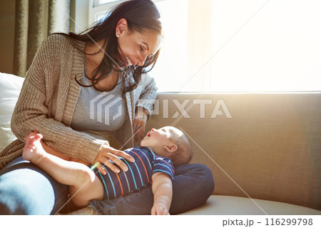 Baby, mother and bonding in living room on sofa with love for relationship with new born, care and embrace. Light, sunshine and relax with smile, happiness and playing on couch with child in house. Baby, mother and bonding in living room on sofa with love for relationship with new born, care and embrace. Light, sunshine and relax with smile, happiness and playing on couch with child in house. 116299798