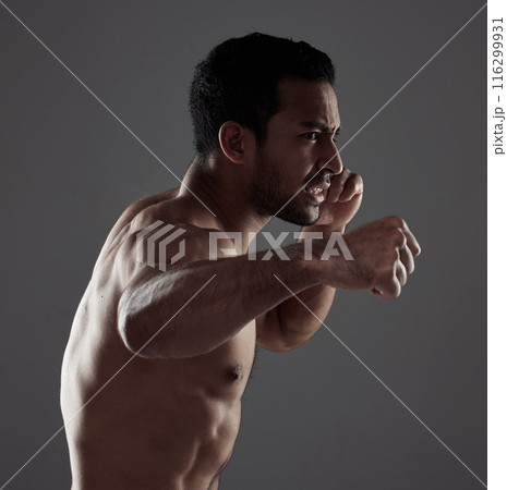 Man, boxer and punch in studio for workout for mma sport, fighter and background or training for challenge or competition fight. Strong, power and exercise for strength, combat fitness and health 116299931