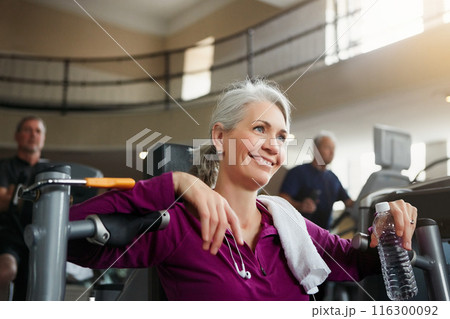 Woman, tired and break from exercise in gym, fitness and water for chest press machine or rest. Female person, mineral liquid and nutrition at health club, mature and sweat or relax after workout Woman, tired and break from exercise in gym, fitness and water for chest press machine or rest. Female person, mineral liquid and nutrition at health club, mature and sweat or relax after workout 116300092