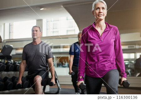 Fitness, weights and mature people in gym for workout, training and exercise class for health. Retirement, lunge and senior men and women with dumbbells for wellness, muscle strength and mobility 116300136