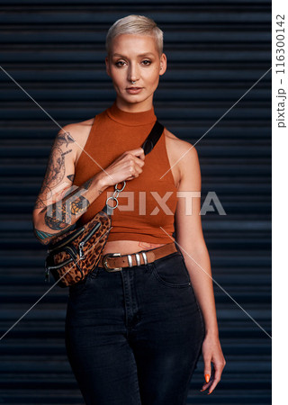 Girl, happy and portrait in fashion outdoor with streetwear, casual style and trendy outfit with tattoos. Woman, person or confidence in city with edgy clothes, grunge or pride with bag in urban town Girl, happy and portrait in fashion outdoor with streetwear, casual style and trendy outfit with tattoos. Woman, person or confidence in city with edgy clothes, grunge or pride with bag in urban town 116300142