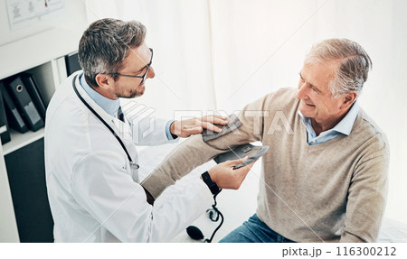 Blood pressure, man and doctor in office with support, help and advice for health insurance. Clinic, senior patient and medical professional at desk with consultation, trust and healthcare at checkup 116300212