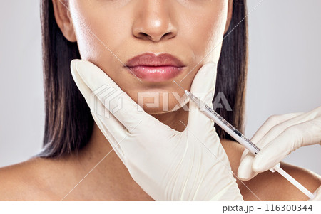 Woman, dermatology and injection with lip filler in surgery for wellness, healthy skin and anti aging. Female person, skincare and cosmetology for results, cosmetic or glowing face in studio backdrop 116300344