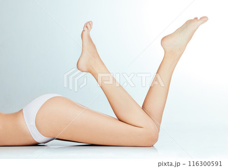 Skincare, underwear and woman legs on floor for wellness with waxing or epilation and beauty in studio. Bikini body, model girl and thigh for hair removal cosmetics and grooming by white background Skincare, underwear and woman legs on floor for wellness with waxing or epilation and beauty in studio. Bikini body, model girl and thigh for hair removal cosmetics and grooming by white background 116300591