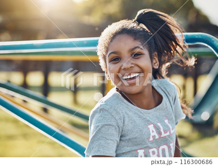 Portrait, child and carousel with playground, smile and love for summer break and play. Kid, face and outdoor park on equipment for joy, fun and happy girl outside with countryside merry go round 116300686