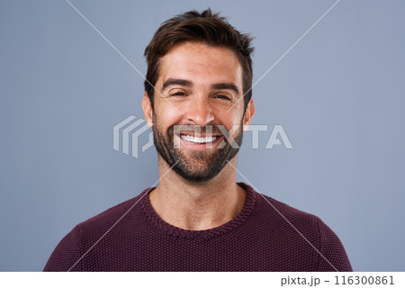 Fashion, face and joy of man in studio, sweater and warm for winter in Canada, happy and discount. Blue background, portrait and smile of person, sale and cardigan of cotton, clothes and jersey 116300861