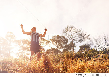 Man, running and achievement with celebration in nature, winning with fitness goals. Male runner, proud and exercise with victory for personal time up mountain, cheering for best speed in marathon 116301094
