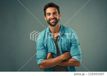 Arms crossed, fashion and happy with portrait of man in studio on gray background for relaxed clothing style. Casual, confident and natural with smile of person in outfit to model clothes or shirt 116301097