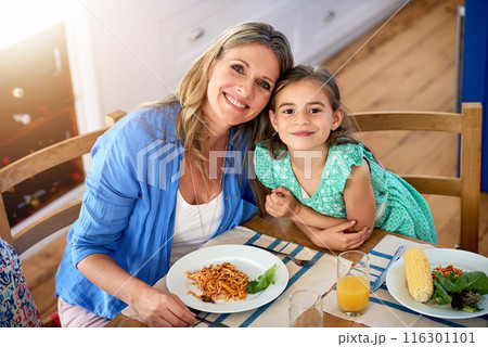 Food, portrait or mom hug daughter in house for mothers day lunch, bonding and eating together. Happy family, support and face of girl with mama at home for pasta brunch, diet or organic nutrition 116301101