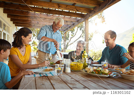 Table, food and family outdoors for lunch, supper and eating meal together for Christmas. Celebration, parents and children with dish for bonding, relax and talking for nutrition, health and wellness 116301102