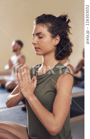 Woman, meditation and namaste in yoga class, breathe and exercise together for peace in studio. Female person, holistic and coach training a group of people, spiritual awareness and yogi for zen 116303032