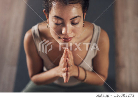 Woman, praying hands and yoga meditating, wellness and calm exercise for workout or health club or balance. Pilates, holistic and spiritual aura or body healing, zen and peace with yogi on floor Woman, praying hands and yoga meditating, wellness and calm exercise for workout or health club or balance. Pilates, holistic and spiritual aura or body healing, zen and peace with yogi on floor 116303272