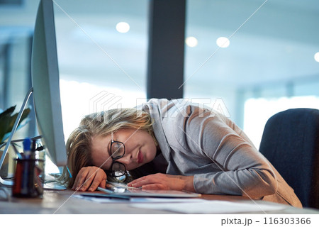 Business woman, desk or sleeping at night with burnout in stress, anxiety or depression at office. Tired female person or employee asleep after working late for rest, break or overworked at workplace 116303366