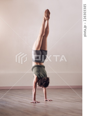 Woman, handstand and yoga exercise in fitness studio of space, body and wellness for health. Back of person, upside down for balance or pilates, agility and strong core for power with flexibility Woman, handstand and yoga exercise in fitness studio of space, body and wellness for health. Back of person, upside down for balance or pilates, agility and strong core for power with flexibility 116303385