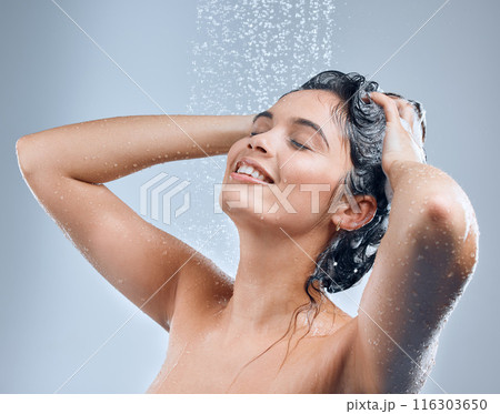 Water, shower and woman for hair care with hygiene, shine results and clean scalp for growth in studio. Liquid drops, model girl and shampoo wash for texture and cleaning routine by grey background 116303650