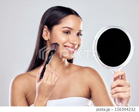 Woman, beauty and make up brush with mirror studio for application, cosmetics and happy for skin. Product, model girl and smile for creativity, artist and pride or confidence for glamour or glow 116304232