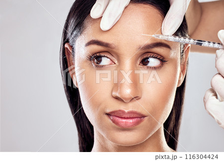 Hand, needle and woman in studio for plastic surgery with beauty transformation and cosmetic procedure. Surgeon injection, client and facial filler for anti aging results and glow by grey background Hand, needle and woman in studio for plastic surgery with beauty transformation and cosmetic procedure. Surgeon injection, client and facial filler for anti aging results and glow by grey background 116304424