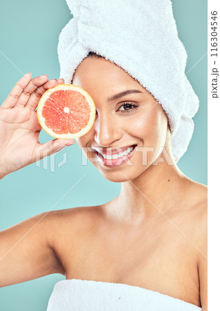 Portrait, skincare and woman with grapefruit for beauty, vegan diet and natural facial glow in studio. citrus food, dermatology and model girl with skin health for vitamin c detox by blue background Portrait, skincare and woman with grapefruit for beauty, vegan diet and natural facial glow in studio. citrus food, dermatology and model girl with skin health for vitamin c detox by blue background 116304546