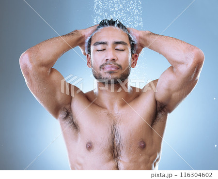Shower, hair care and face of man with water splash for hygiene, grooming or shampoo on studio background. Wash, body and Asian model with eyes closed for treatment, wellness or morning routine Shower, hair care and face of man with water splash for hygiene, grooming or shampoo on studio background. Wash, body and Asian model with eyes closed for treatment, wellness or morning routine 116304602