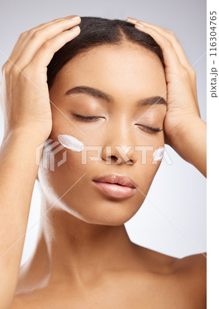 Calm, face and woman with sunscreen for skincare and dermatology in studio background. Model, relax and girl with moisturizer lotion on skin for healthy glow or cream for natural beauty and cosmetics 116304765