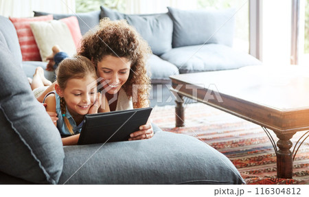 Mother, tablet and kid in streaming as family on weekend, break at home for online gaming or movies. Excited, people and lounge for relax, together or bonding as parent or growth, development or love Mother, tablet and kid in streaming as family on weekend, break at home for online gaming or movies. Excited, people and lounge for relax, together or bonding as parent or growth, development or love 116304812