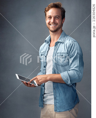 Studio, portrait and student with tablet, smile and internet for message, texting and online in social media of app. Gray background, happy and person with tech, man and connection for communication 116304826