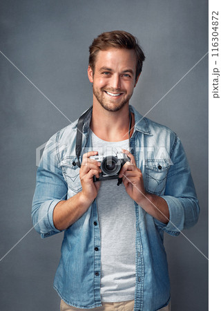 Camera, happy and portrait of man in studio for digital production, media and photoshoot. Smile, photographer and happy with dslr equipment for creative, art and journalist on blue background 116304872