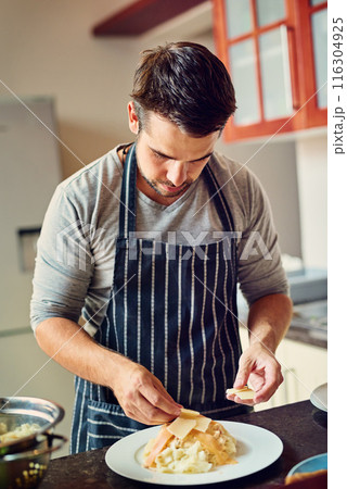Man, chef and cooking food in home for dinner or eating on kitchen counter with pasta and cheese. Male person, dish and meal prep for lunch, brunch and wellness with recipe for dining in house Man, chef and cooking food in home for dinner or eating on kitchen counter with pasta and cheese. Male person, dish and meal prep for lunch, brunch and wellness with recipe for dining in house 116304925