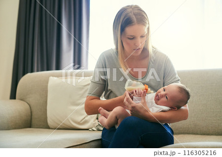 Mother, milk bottle and feed baby on sofa in living room for growth development, nutrition or digestive health. Love, formula and woman with infant child for drinking, wellness or bonding in home Mother, milk bottle and feed baby on sofa in living room for growth development, nutrition or digestive health. Love, formula and woman with infant child for drinking, wellness or bonding in home 116305216