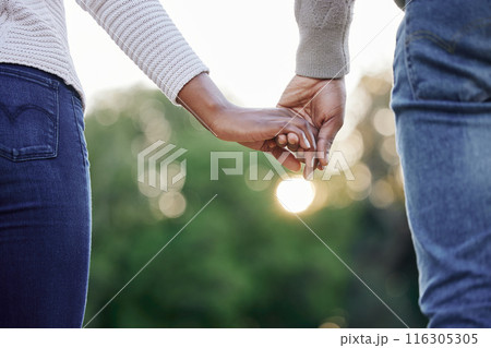 Travel, closeup and couple holding hands at park for anniversary date, trust or honeymoon romance. Wellness, vacation trip and people in nature with support, care and love on holiday break in garden Travel, closeup and couple holding hands at park for anniversary date, trust or honeymoon romance. Wellness, vacation trip and people in nature with support, care and love on holiday break in garden 116305305