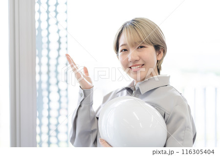 作業服を着てヘルメットを持つ金髪ショートヘアの若い女性（OK、髪色自由、自分らしく働く、職場環境） 116305404