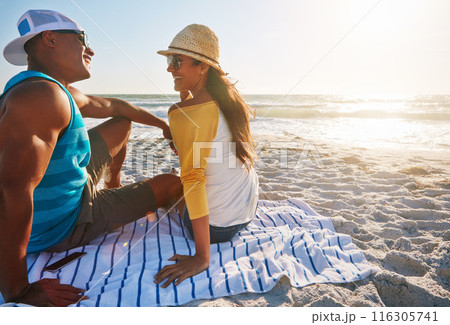 Love, relax and couple with sunglasses on beach for adventure, holiday and bonding with laugh. Outdoor, towel and seaside with happy people, boyfriend and girlfriend for sunset on vacation in Bali Love, relax and couple with sunglasses on beach for adventure, holiday and bonding with laugh. Outdoor, towel and seaside with happy people, boyfriend and girlfriend for sunset on vacation in Bali 116305741