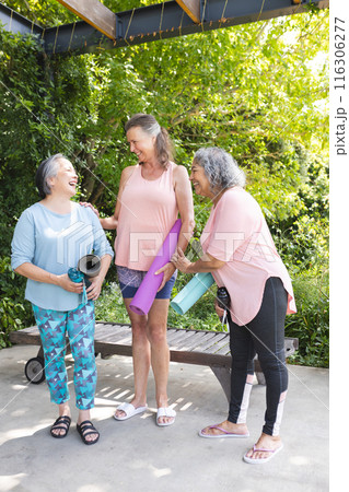 Outdoors, diverse senior female friends laughing together 116306277