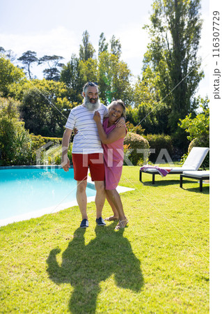 Outdoors, diverse senior friends laughing in sunny garden 116307729