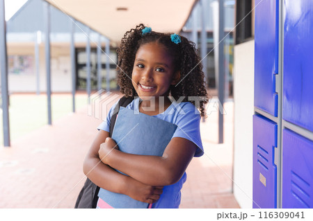 Biracial girl stands confidently at school Biracial girl stands confidently at school 116309041