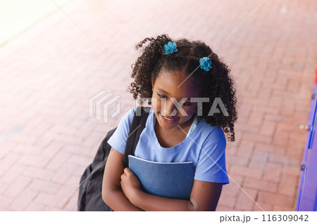Biracial girl stands ready for school Biracial girl stands ready for school 116309042