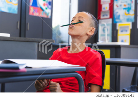 Biracial boy enjoys a playful moment at school Biracial boy enjoys a playful moment at school 116309143