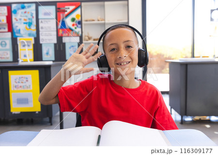 Biracial boy enjoys a learning session at school on a video call Biracial boy enjoys a learning session at school on a video call 116309177