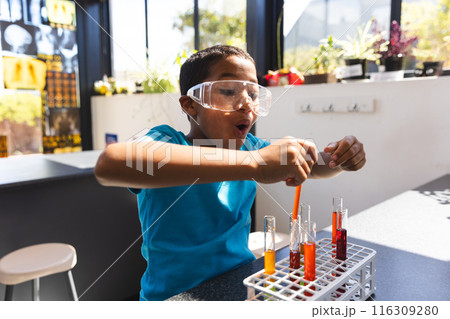 Biracial boy engages in a science experiment at home Biracial boy engages in a science experiment at home 116309280
